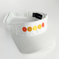 white visor with 5 orange pickleballs