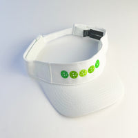 white visor with 5 green pickleballs